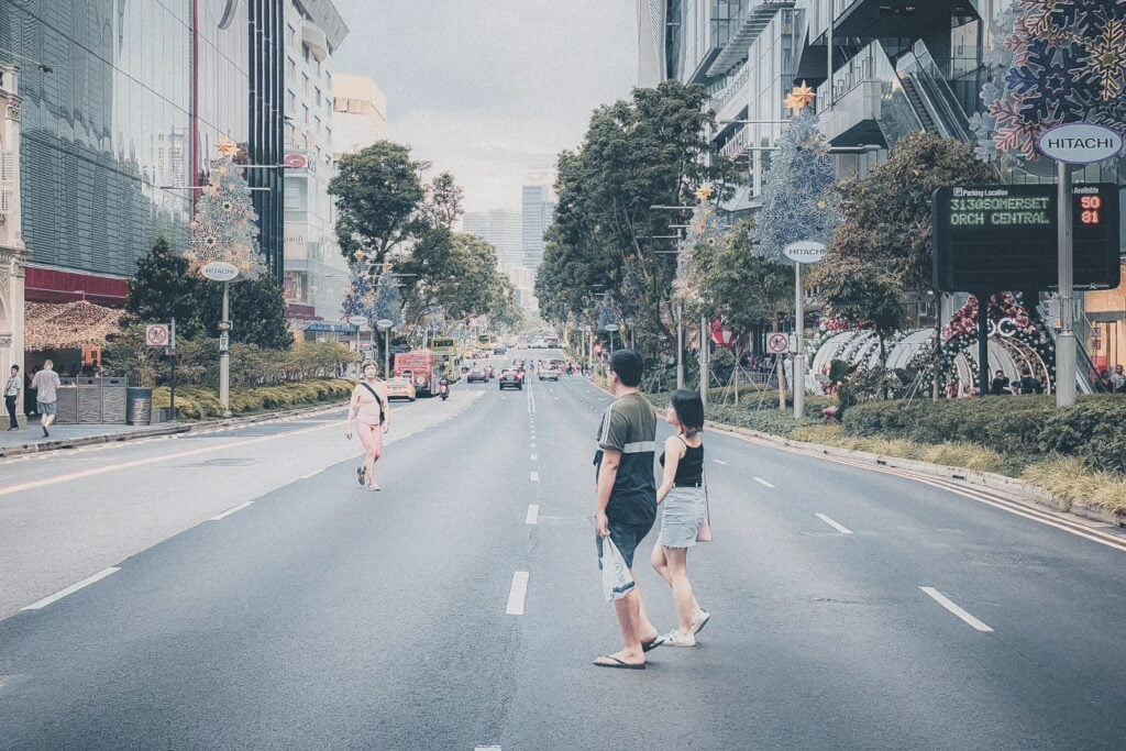 Why Is Singapore So Strict? 24 Rules To Know Before Visiting 5 Couple Crossing Orchard Road Shopping Street