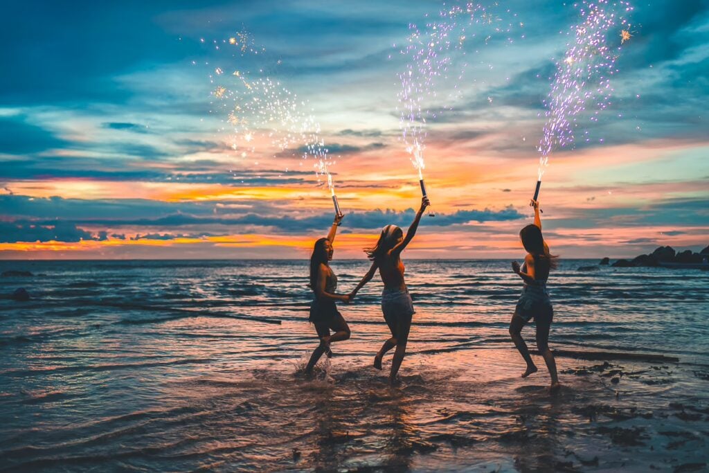 Why Is Singapore So Strict? 24 Rules To Know Before Visiting 16 Young Asian Woman Dancing Sparklers Firework Beach