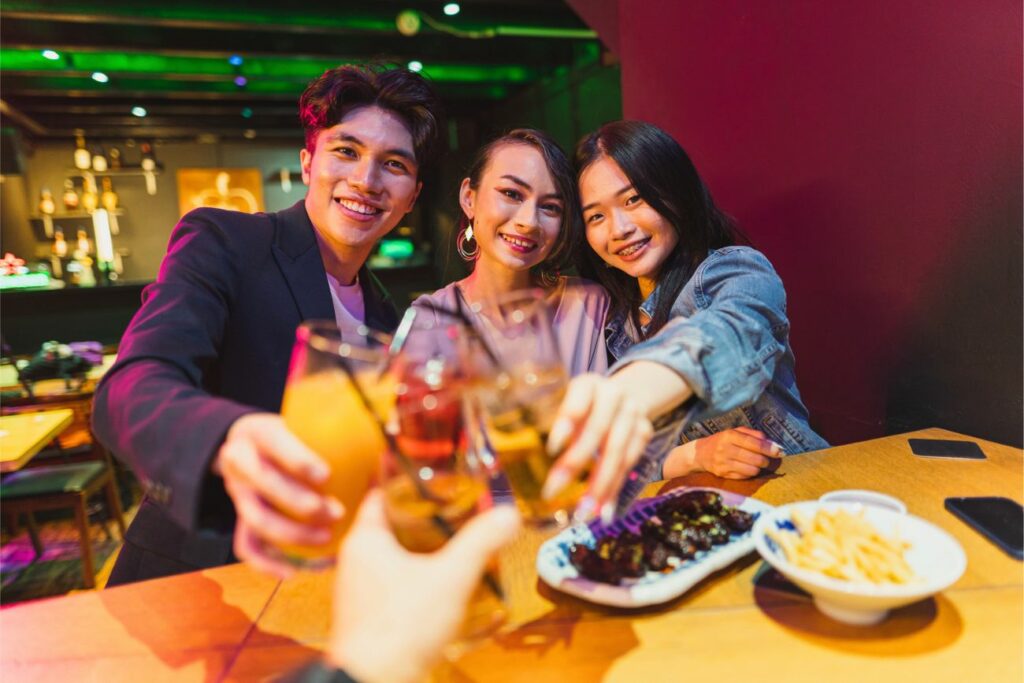Three Asian Young Adults Toasting