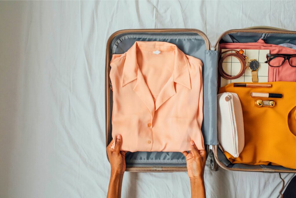 Woman Packing Clothes Suitcase