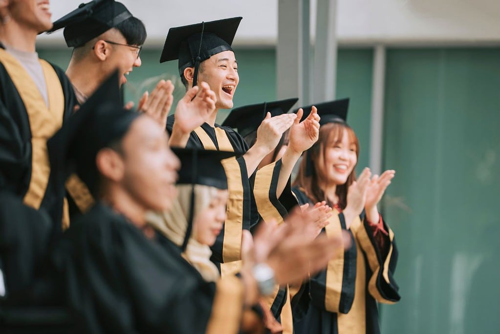 Students Graduation Gown Clapping Hands