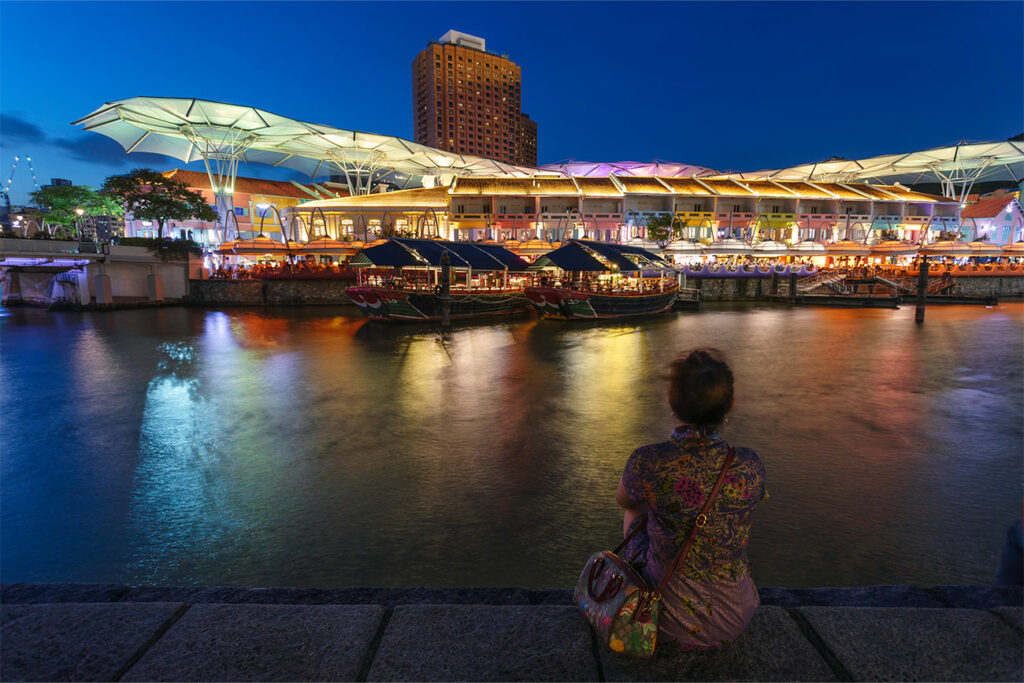 Woman Sitting By The River Clarke Quay Singapore