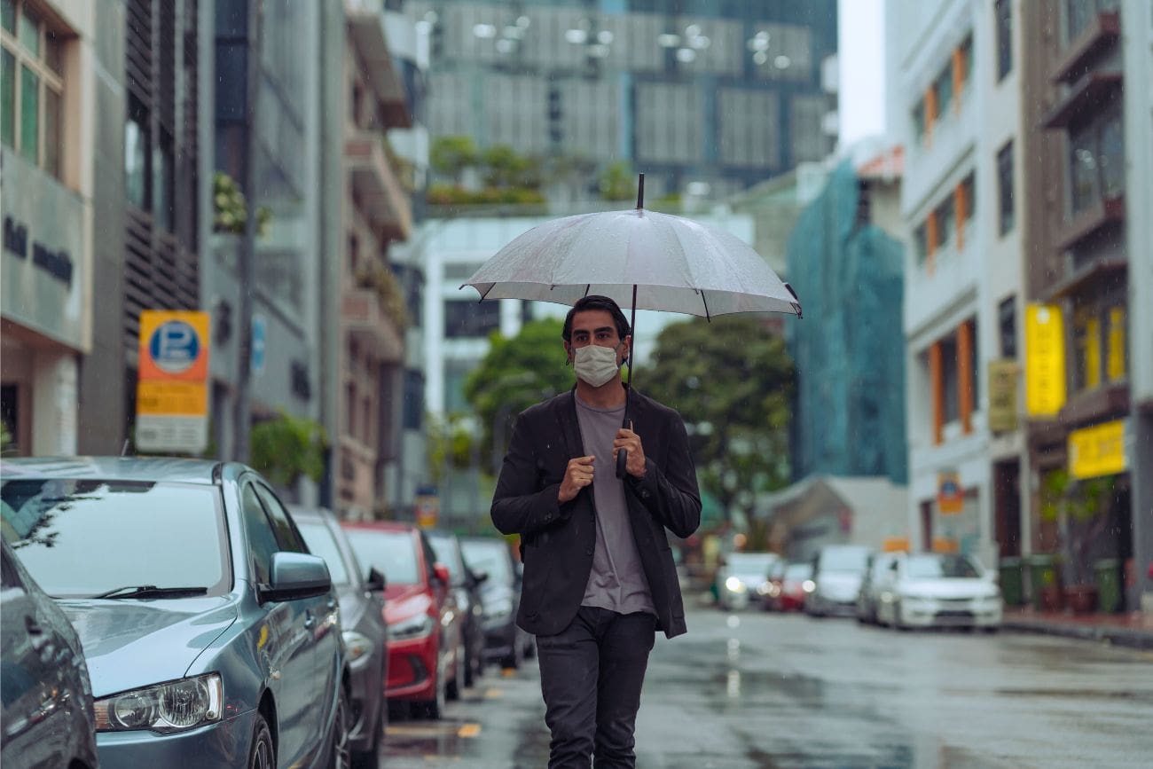 Worst Time To Visit Singapore: Tourist Advisories 10 Young Man Walking Along City Streets Gloomy Weather