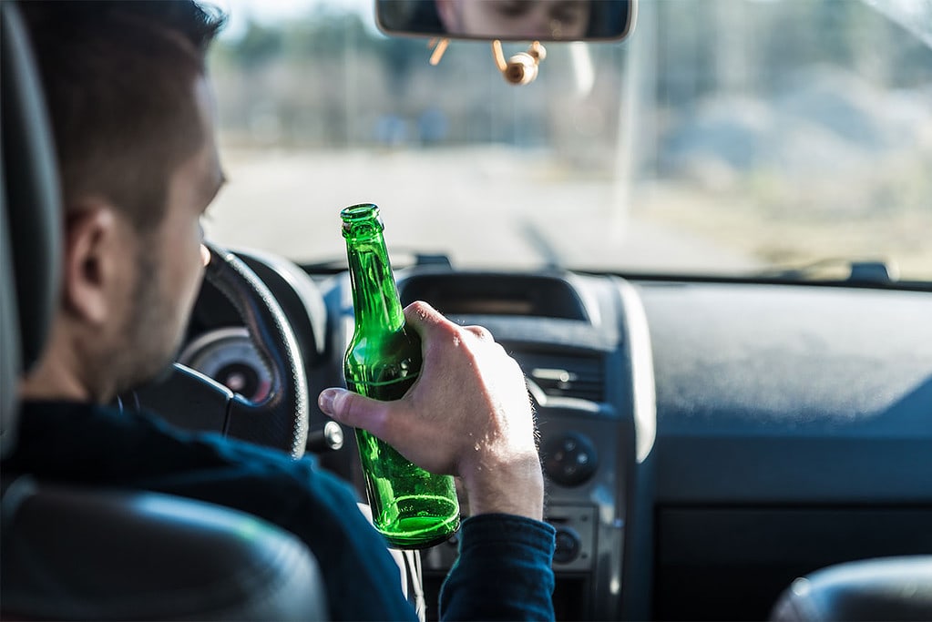 Man Drinking Beer Driving Car