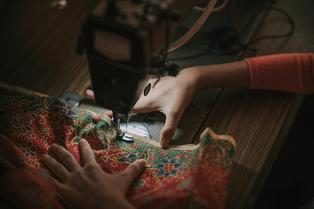 Hand Holding Batik Sewing Stitching Sewing Machine