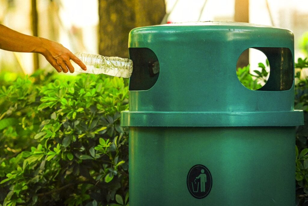 Throwing Empty Plastic Bottle in Bin